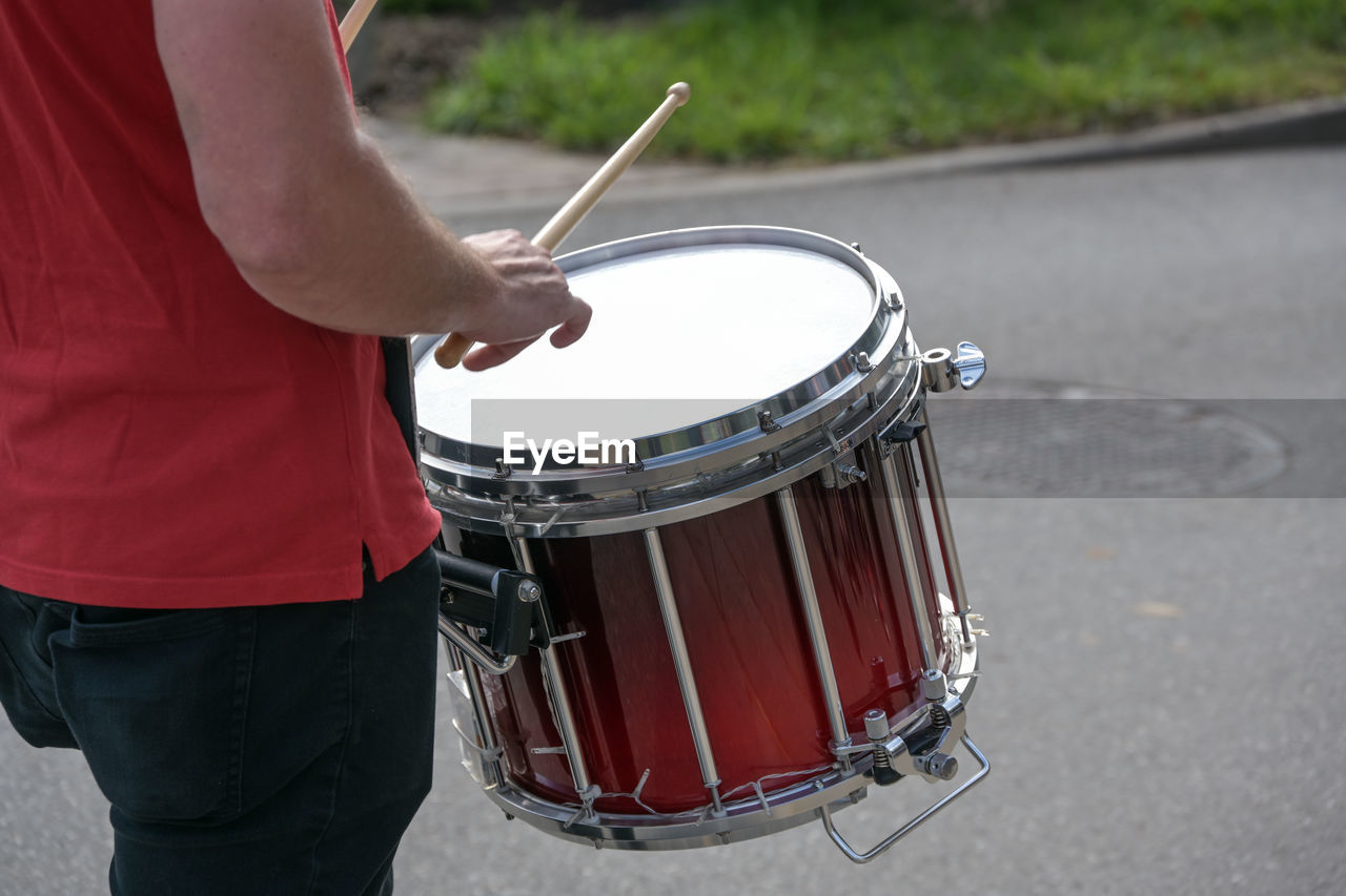 musical instrument, music, musical equipment, drum, drum - percussion instrument, musician, arts culture and entertainment, one person, performance, membranophone, drummer, percussion instrument, bass drum, drumstick, skill, adult, midsection, percussion, men, hand drum, drum kit, drums, lifestyles, day, leisure activity, street, city