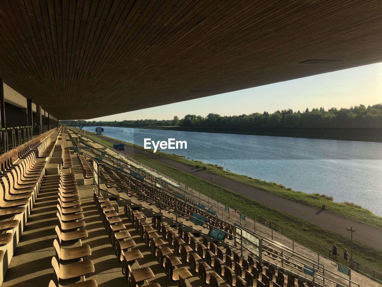 Scenic view of grandstand at lake against sky