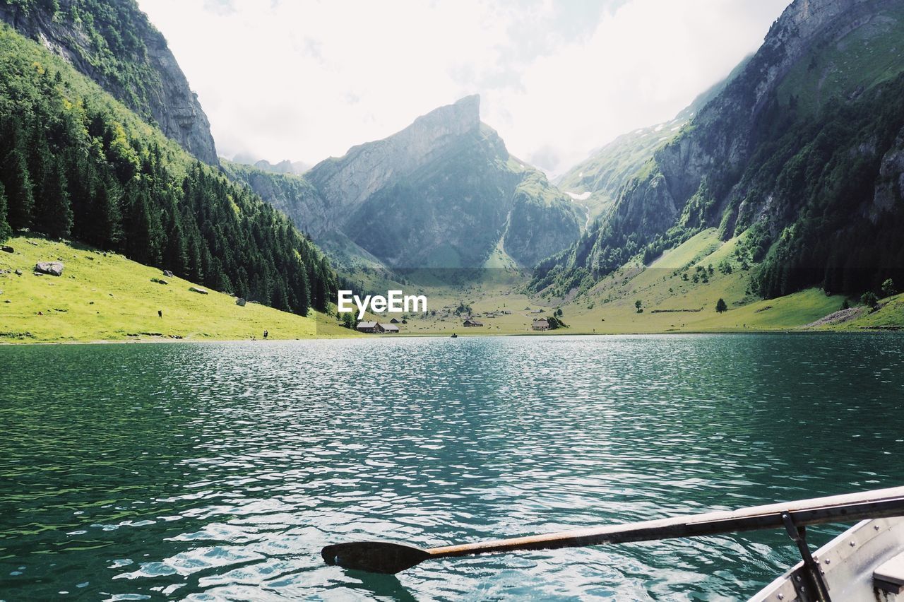 Scenic view of lake and mountains against sky