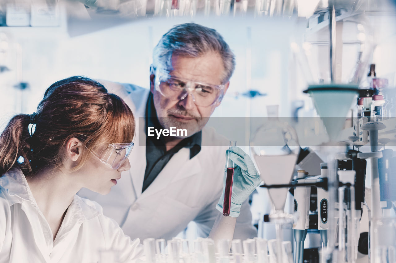 portrait of female friends standing in laboratory