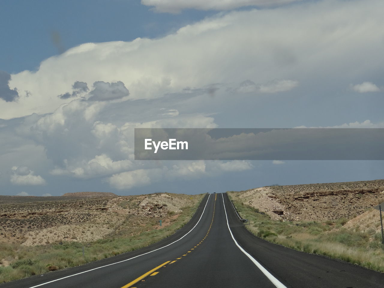 Empty road passing through landscape