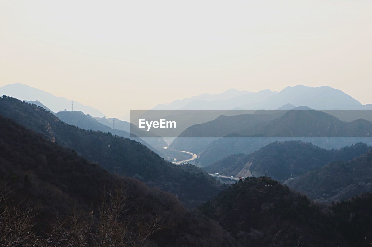 Scenic view of mountains against sky at sunset