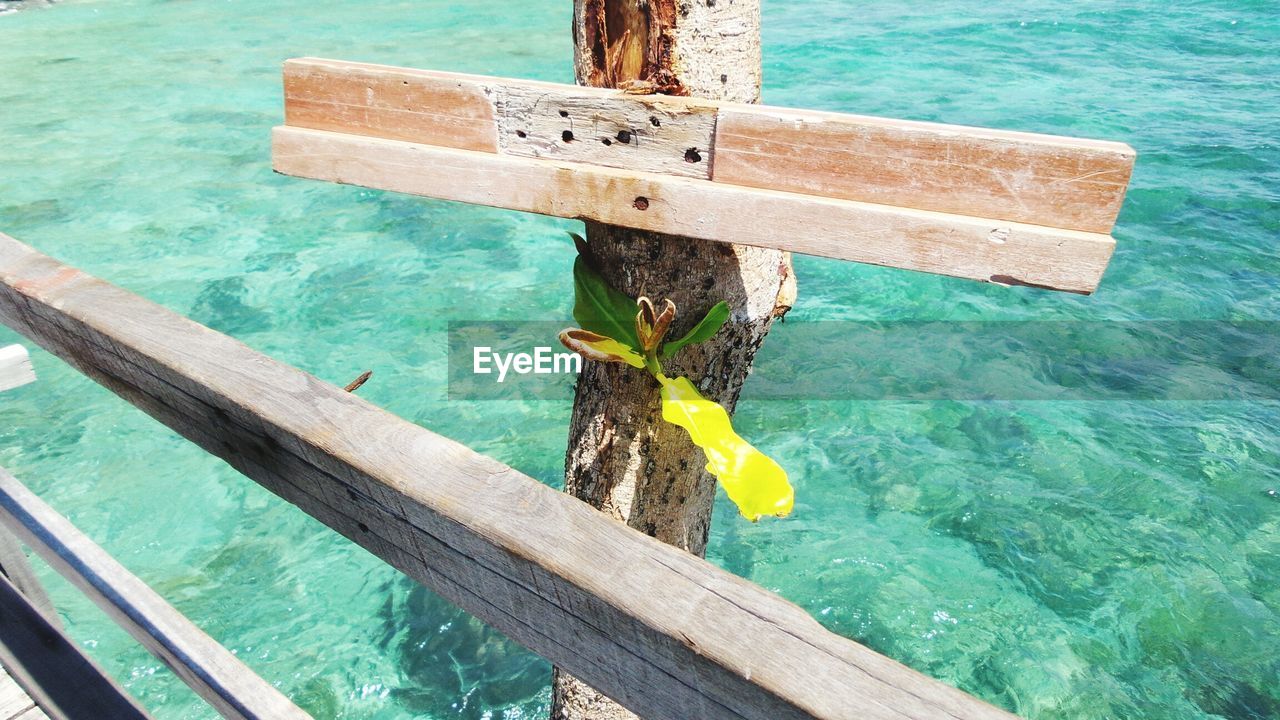 CLOSE-UP OF WOODEN POST IN SWIMMING POOL