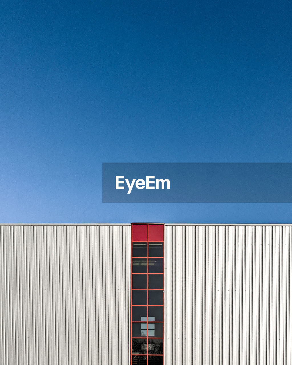 Low angle view of building against clear blue sky