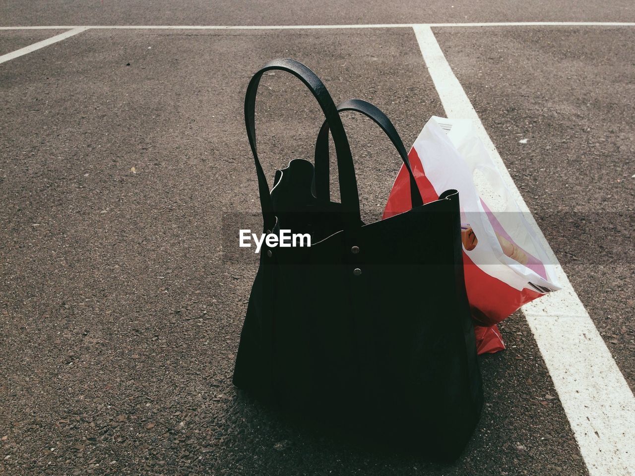 Black purse and plastic bag