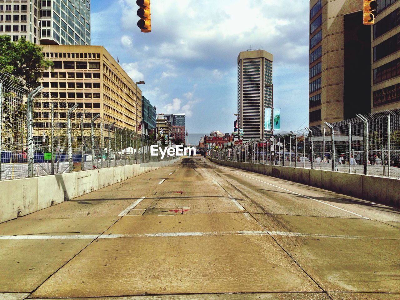 Empty road along buildings
