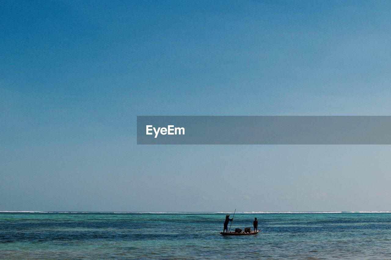 MAN ON SEA AGAINST CLEAR SKY