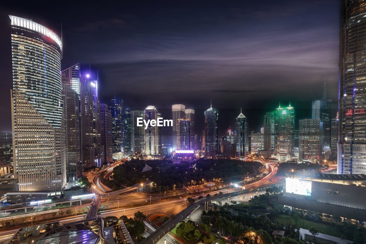 Illuminated buildings against sky at night