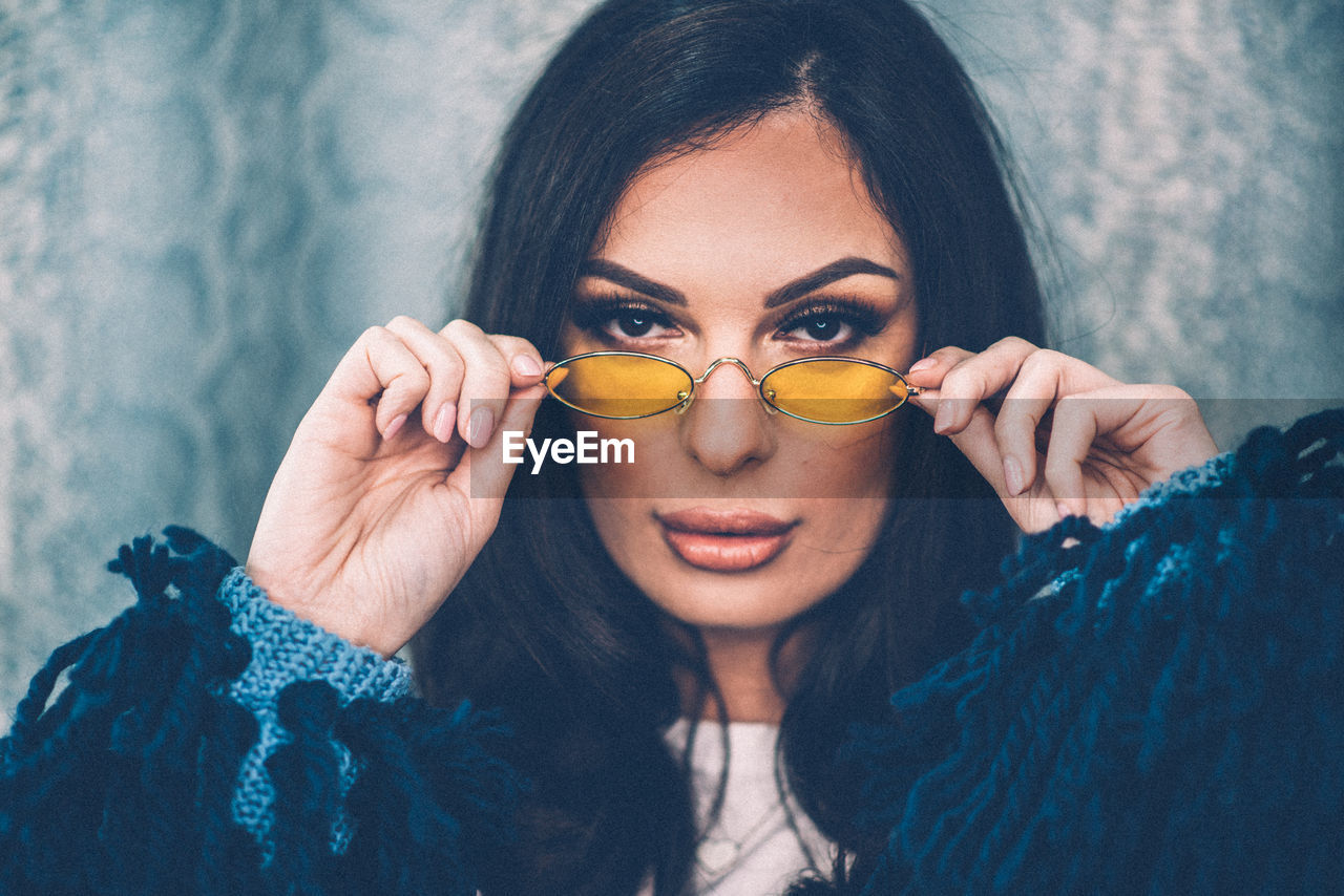 Close-up portrait of beautiful woman wearing sunglasses