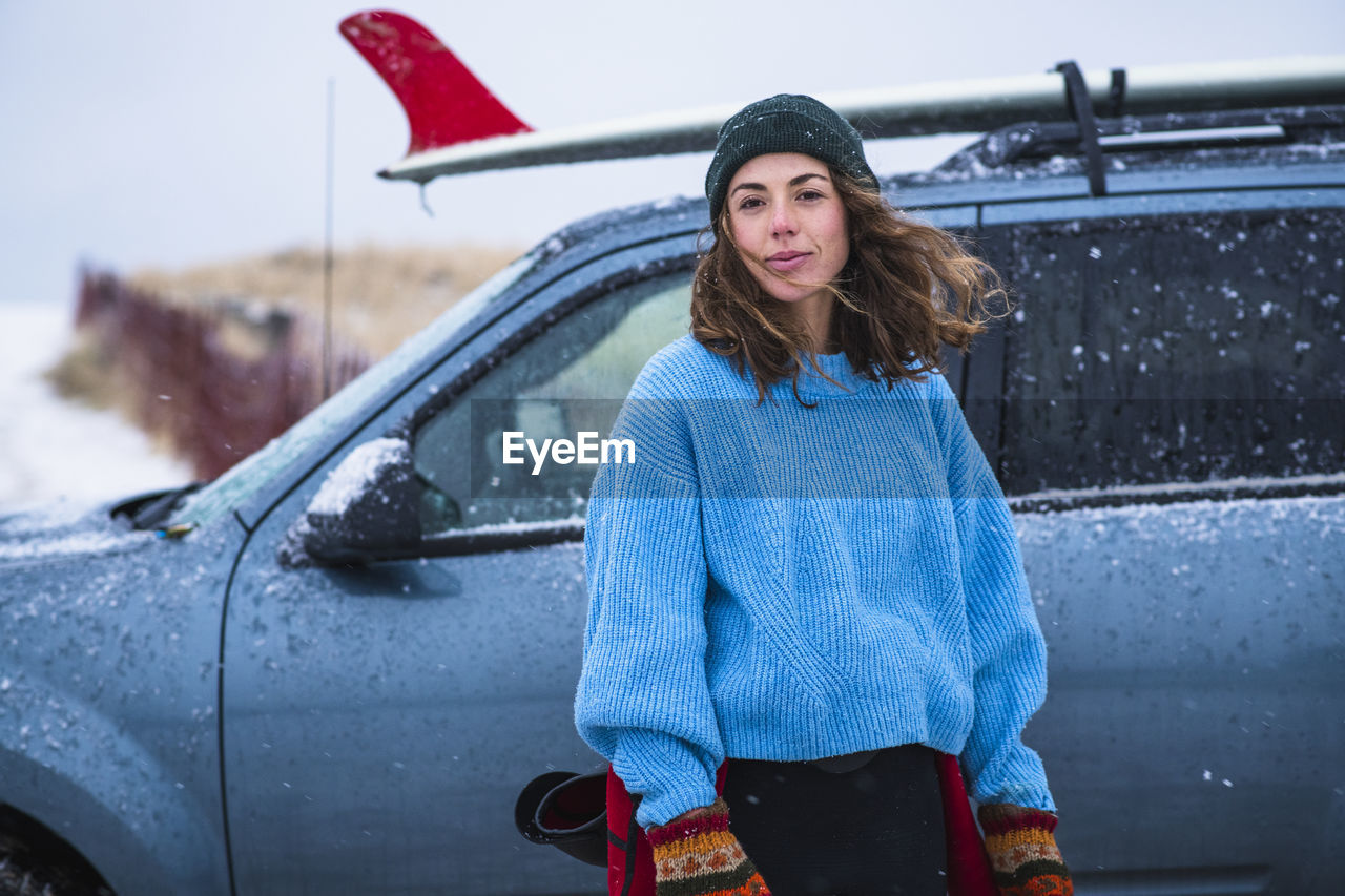 Woman surfer portrait with frozen surfboard