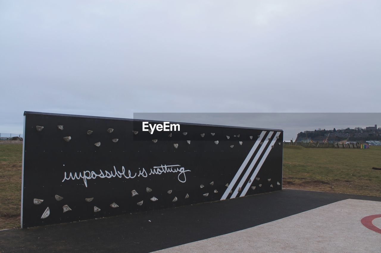 TEXT WRITTEN ON WALL AGAINST SKY