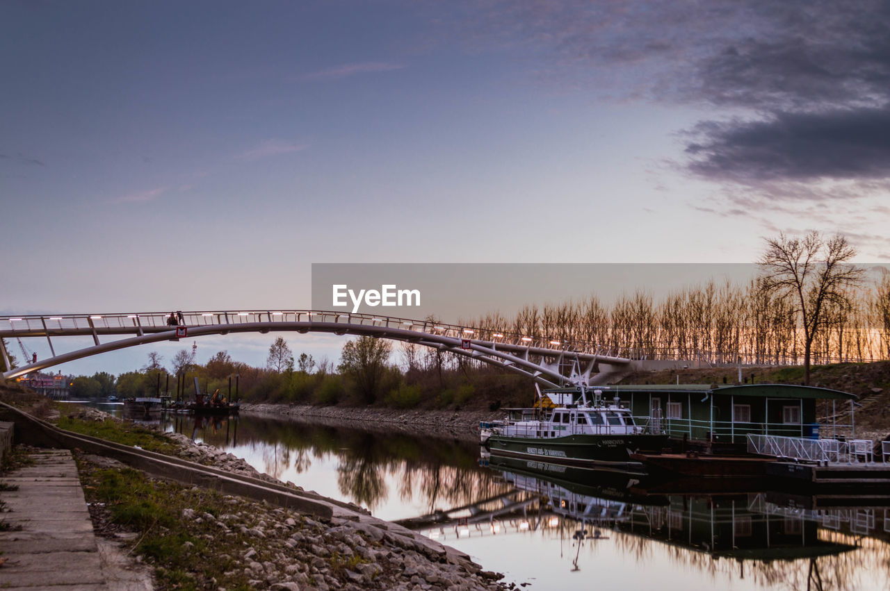 Footbridge over canal against sky