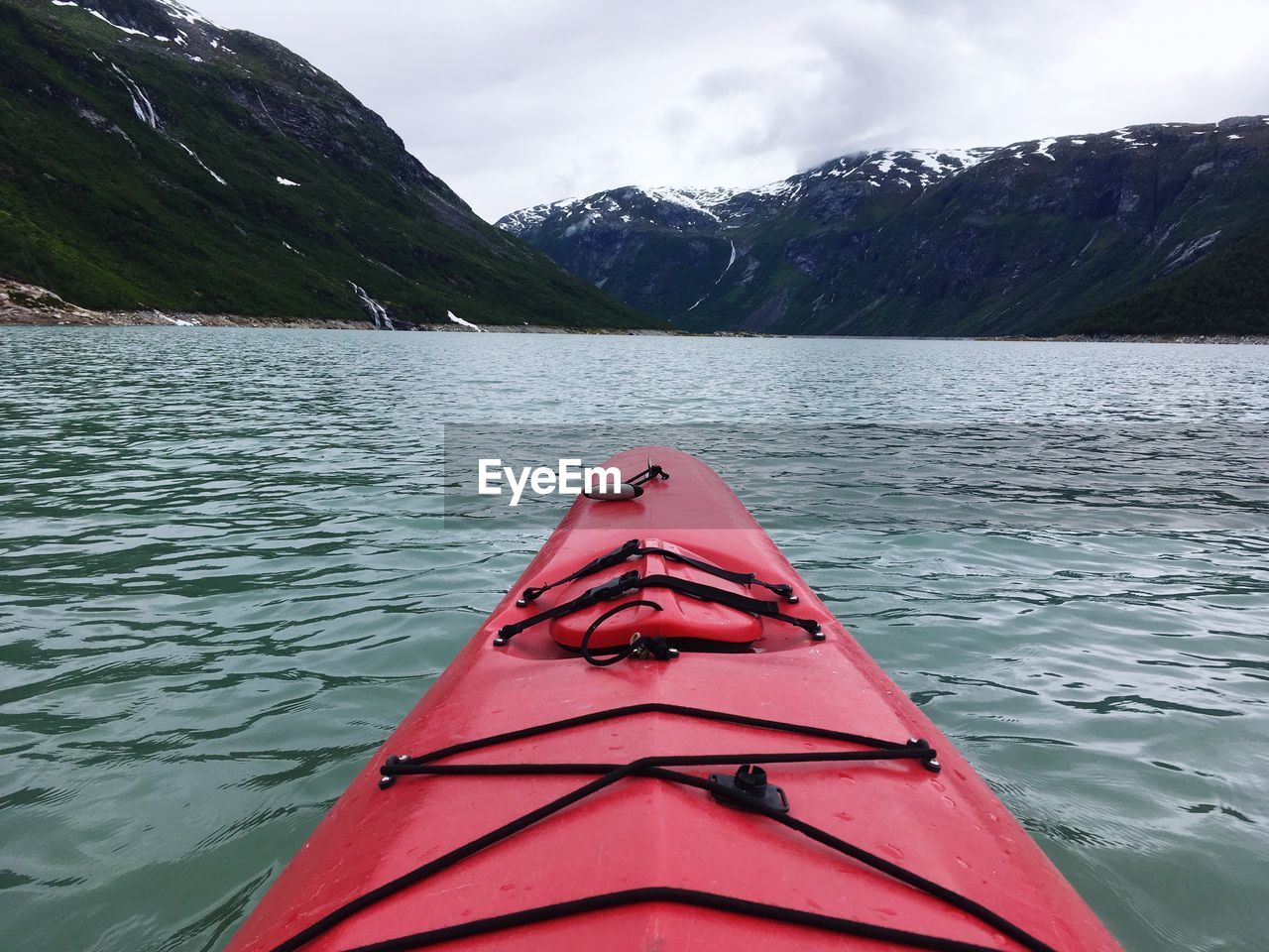 Close-up of kayak on lake against mountains