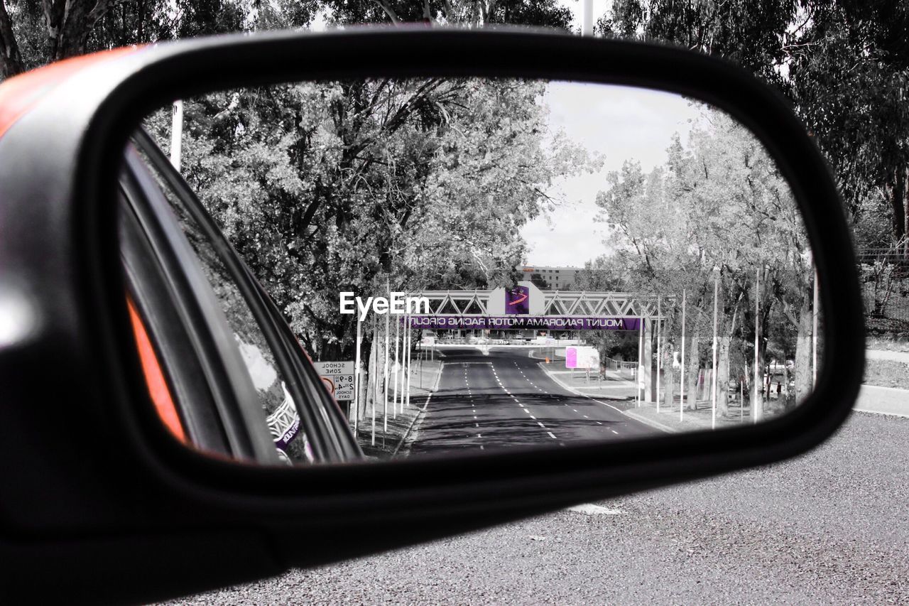 CLOSE-UP OF SIDE-VIEW MIRROR OF CAR