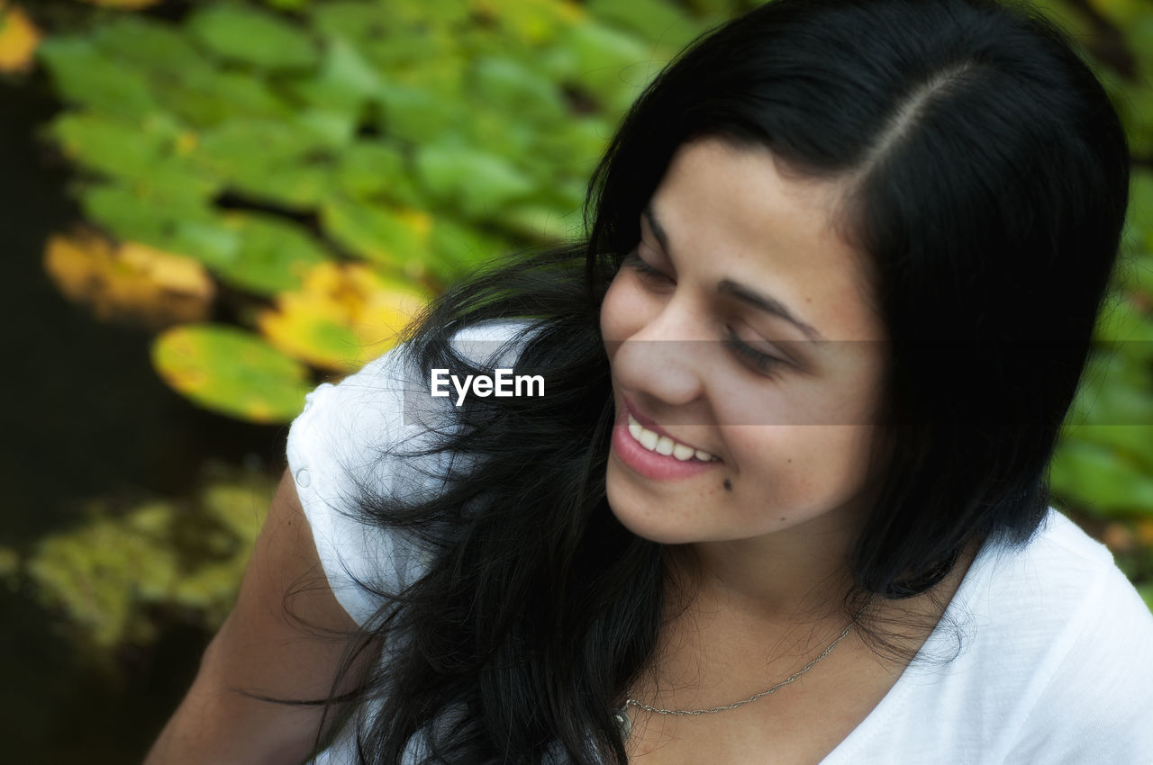 Close-up of young woman smiling outdoors