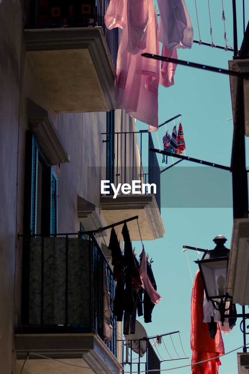 Clothes drying on strings outside houses