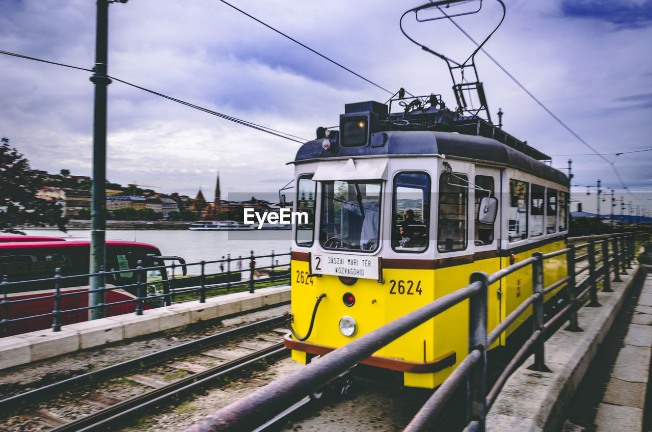 Cable car in city against sky