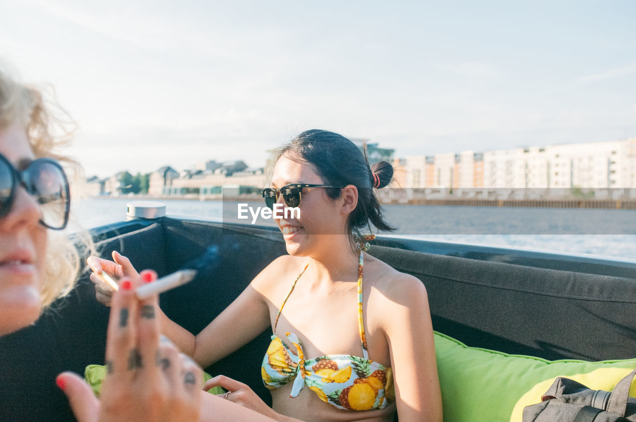 Women sitting and enjoying in boat at river