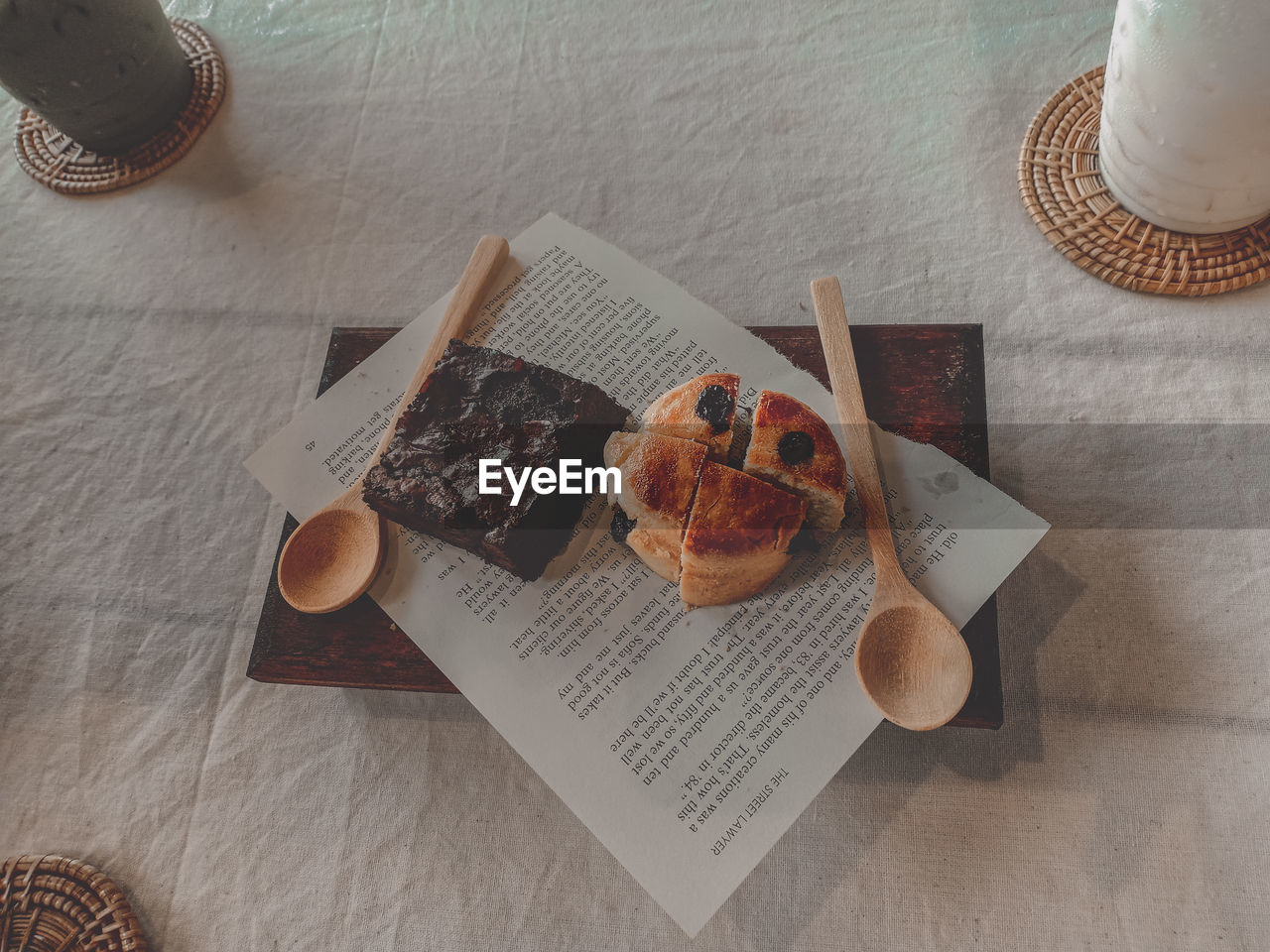 HIGH ANGLE VIEW OF BREAKFAST SERVED ON TABLE WITH BOOK