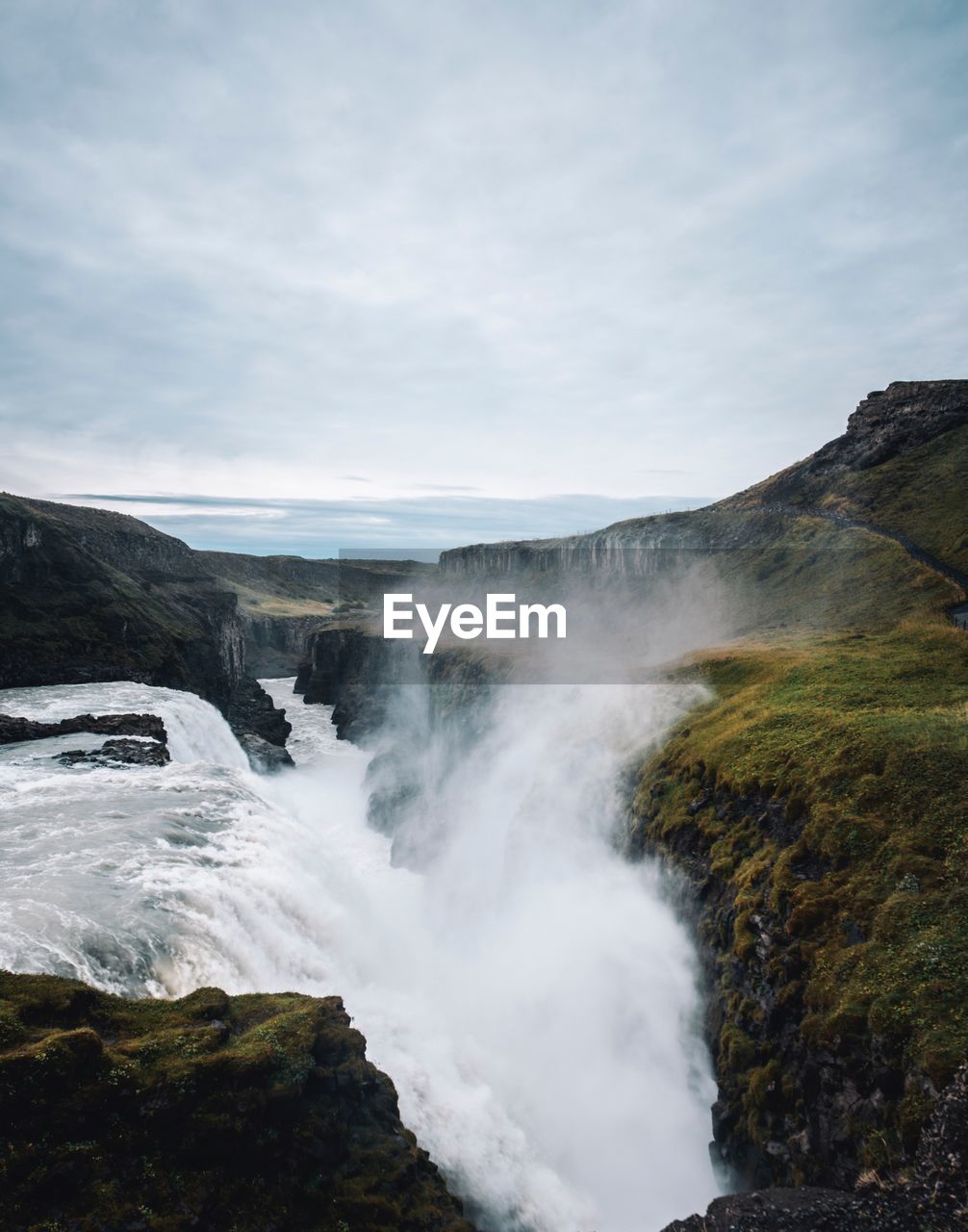 Idyllic view of waterfall against sky