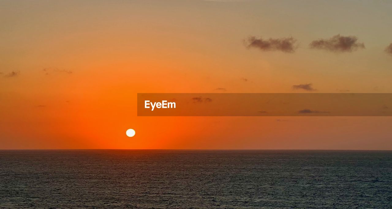 sky, sunset, beauty in nature, sea, water, scenics - nature, horizon, horizon over water, tranquility, nature, orange color, tranquil scene, sun, idyllic, afterglow, ocean, dramatic sky, environment, cloud, no people, seascape, dawn, urban skyline, sunlight, outdoors, land, travel, travel destinations, landscape, silhouette, non-urban scene, evening, awe, romantic sky, beach, coast, atmospheric mood, vacation
