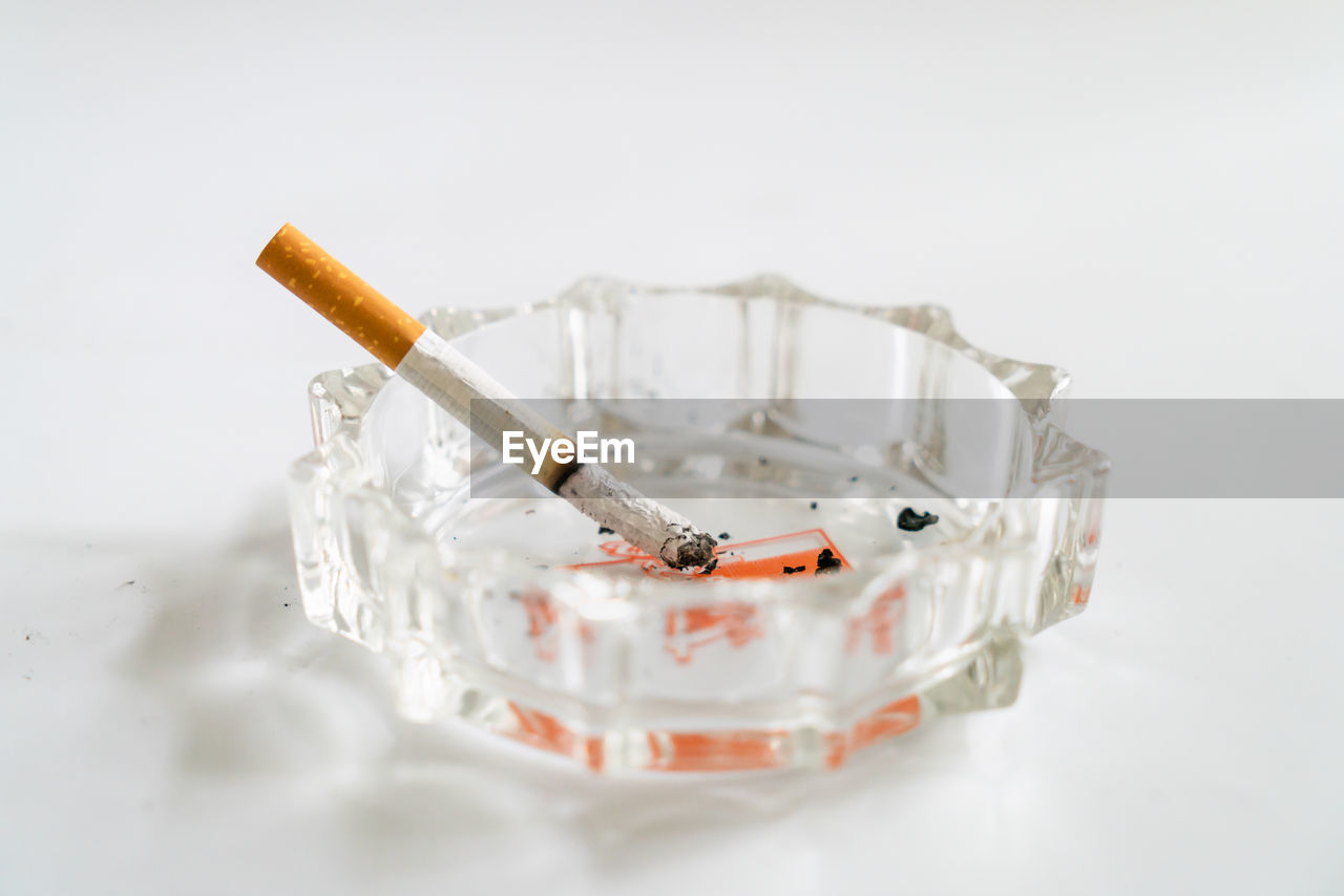 HIGH ANGLE VIEW OF CIGARETTE IN CONTAINER