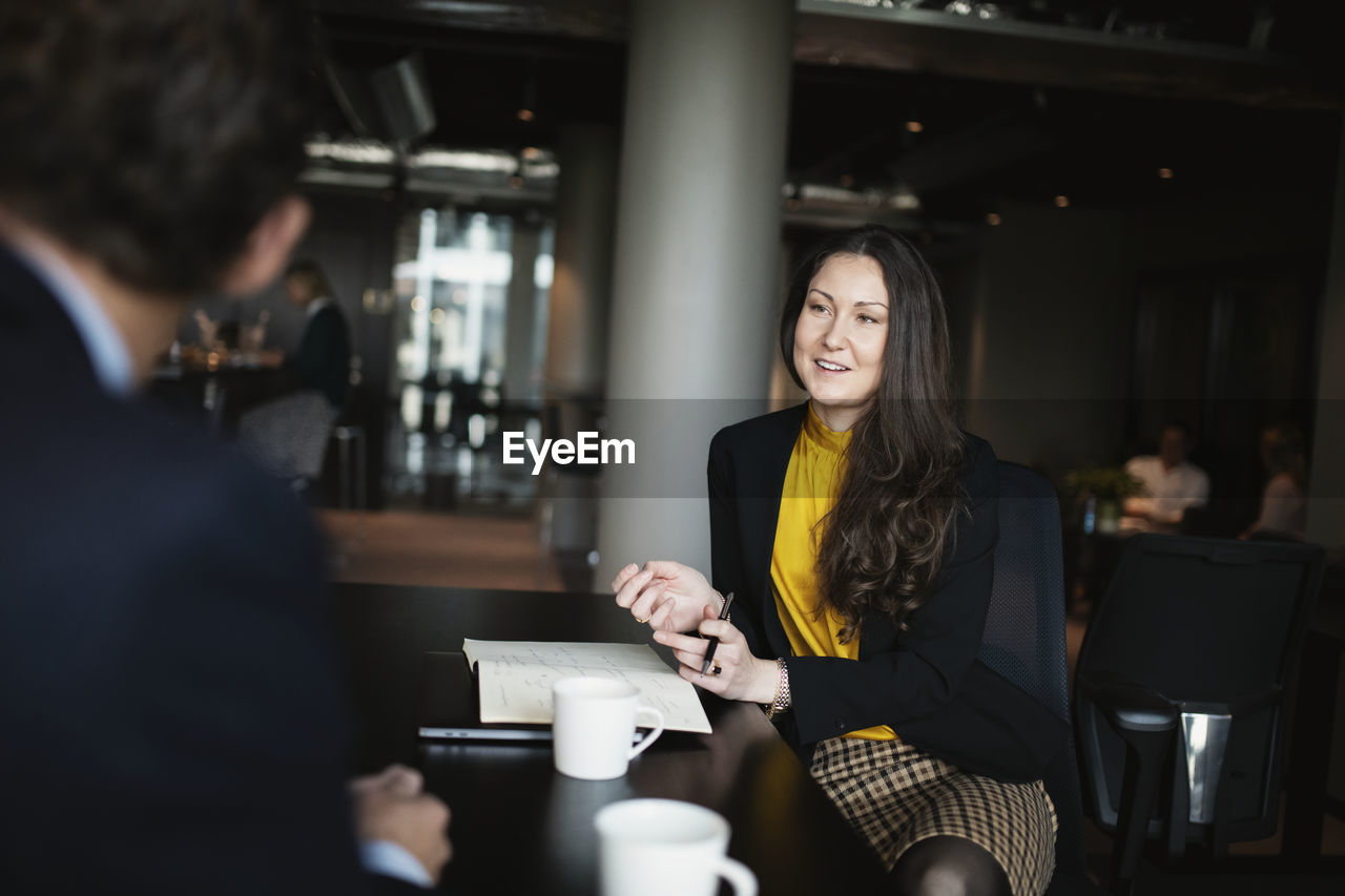 Smiling businesswoman talking in restaurant