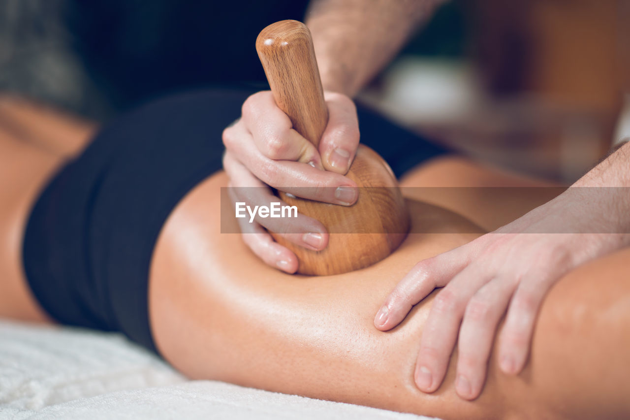 Midsection of man giving massage to woman