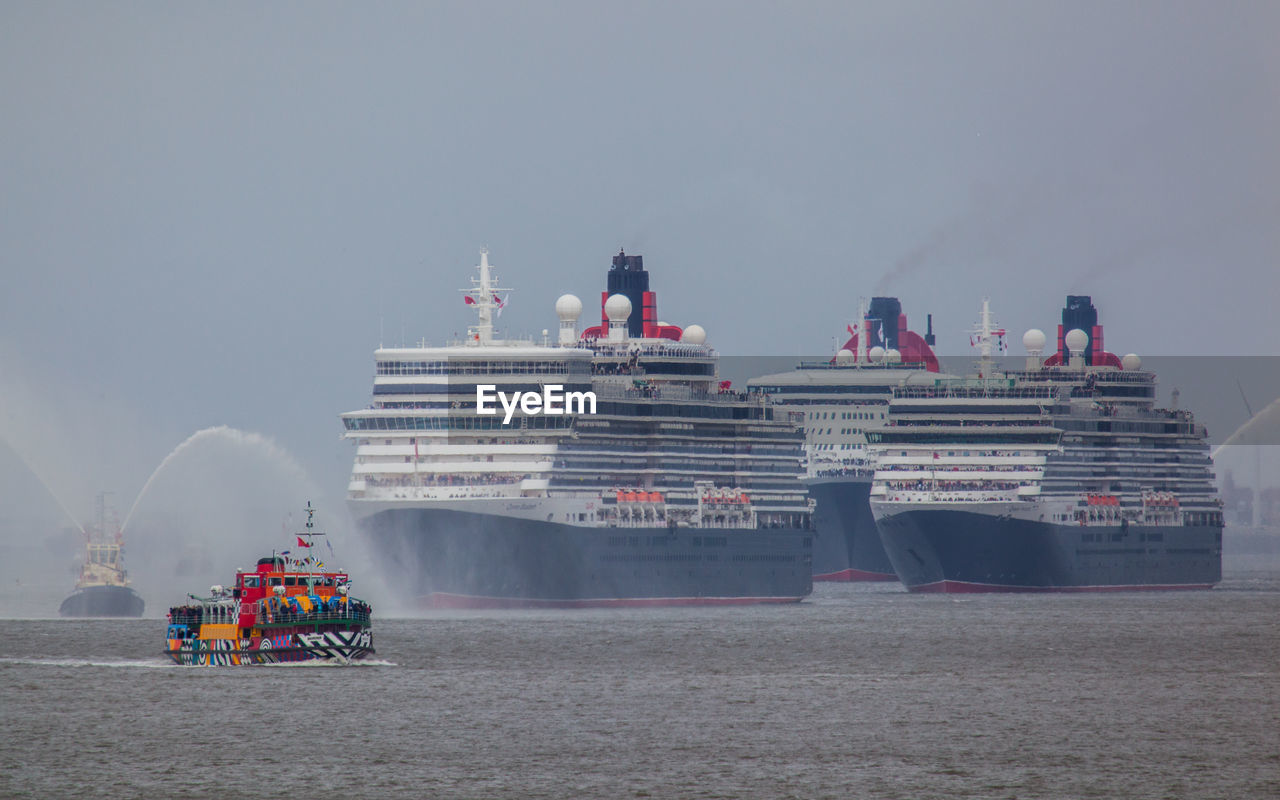 Cruise ships in river against clear sky