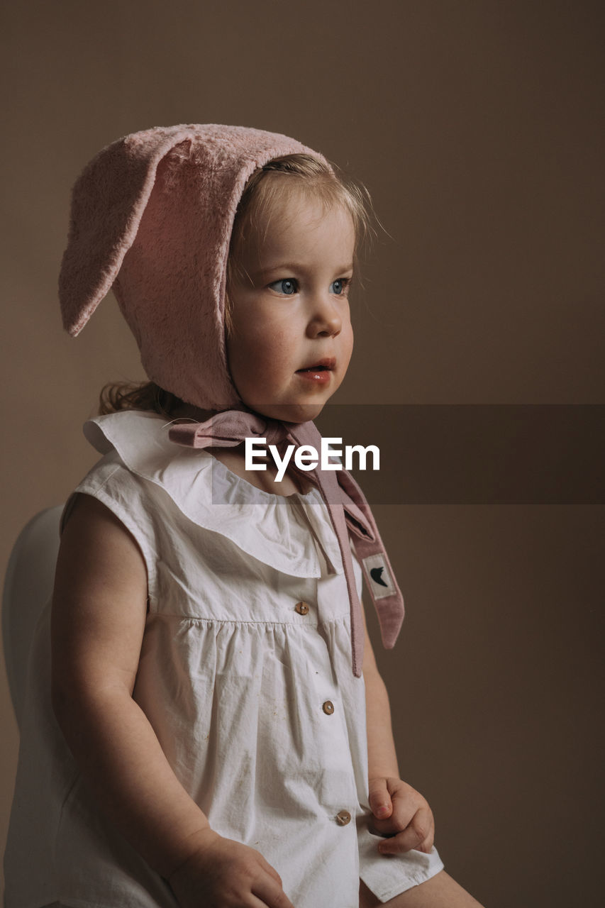 Toddler baby girl in funny hat with ears having fun