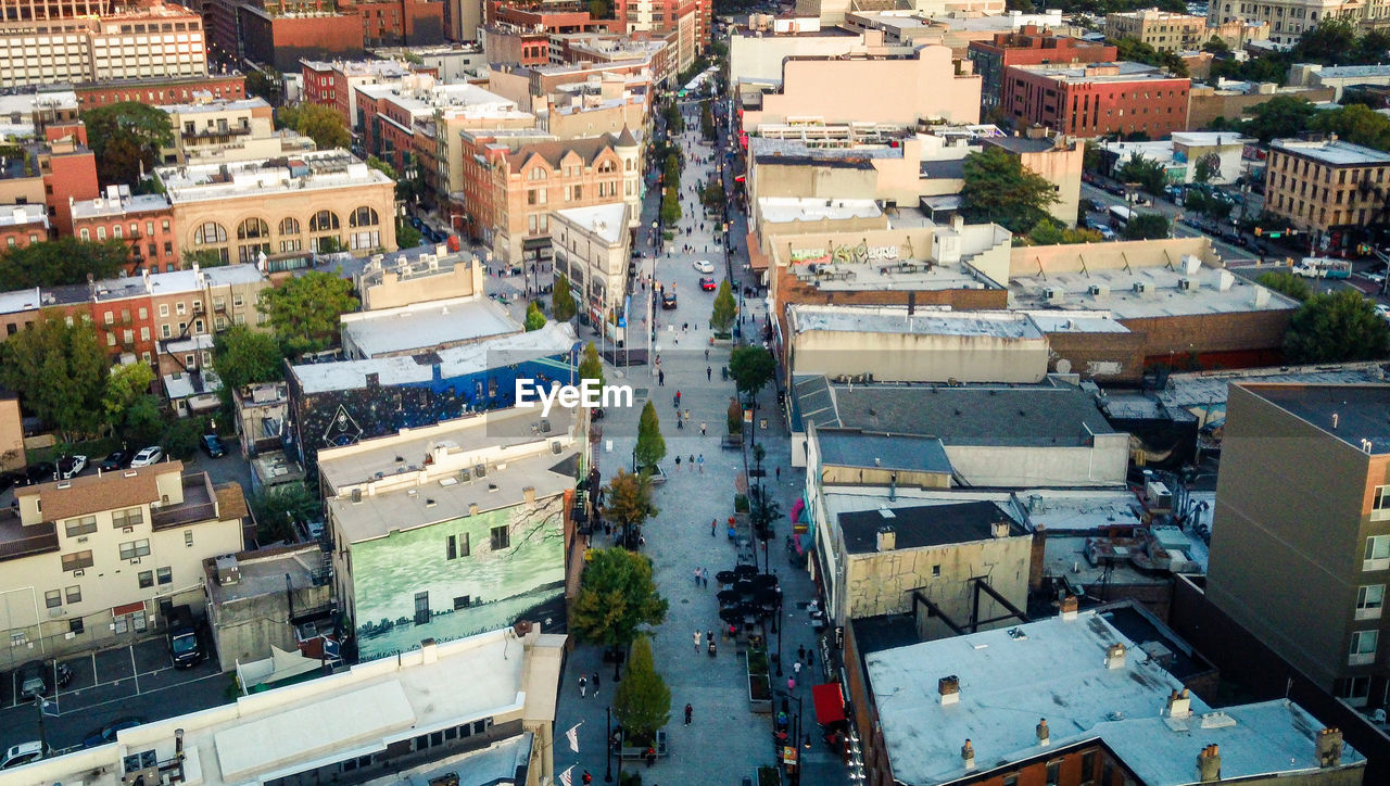 architecture, city, building exterior, high angle view, neighbourhood, built structure, urban area, aerial photography, cityscape, building, residential area, bird's-eye view, metropolitan area, town, downtown, roof, suburb, residential district, metropolis, crowd, aerial view, crowded, skyline, transportation, nature, street, day, outdoors, city life, mode of transportation, road, skyscraper, house, city street, car