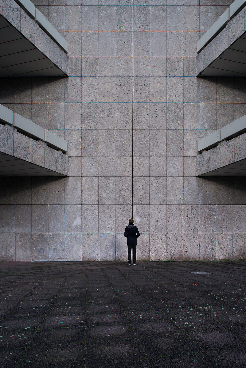 FULL LENGTH OF YOUNG WOMAN STANDING IN BUILDING