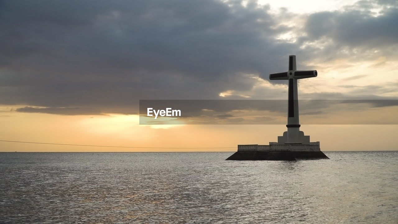 Sunken cemetery cross in camiguin island. large crucafix marking the underwater sunken cemetary
