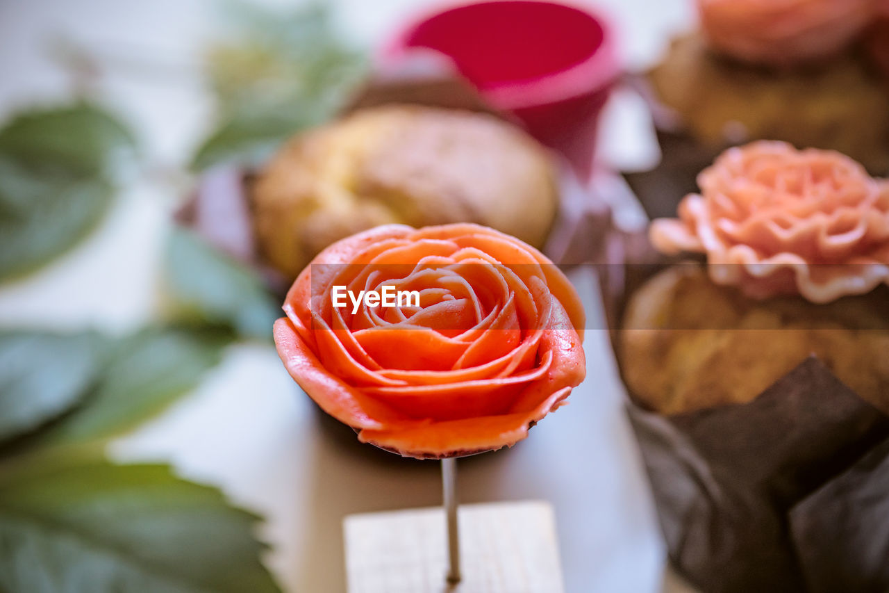 CLOSE-UP OF CAKE ON ROSE