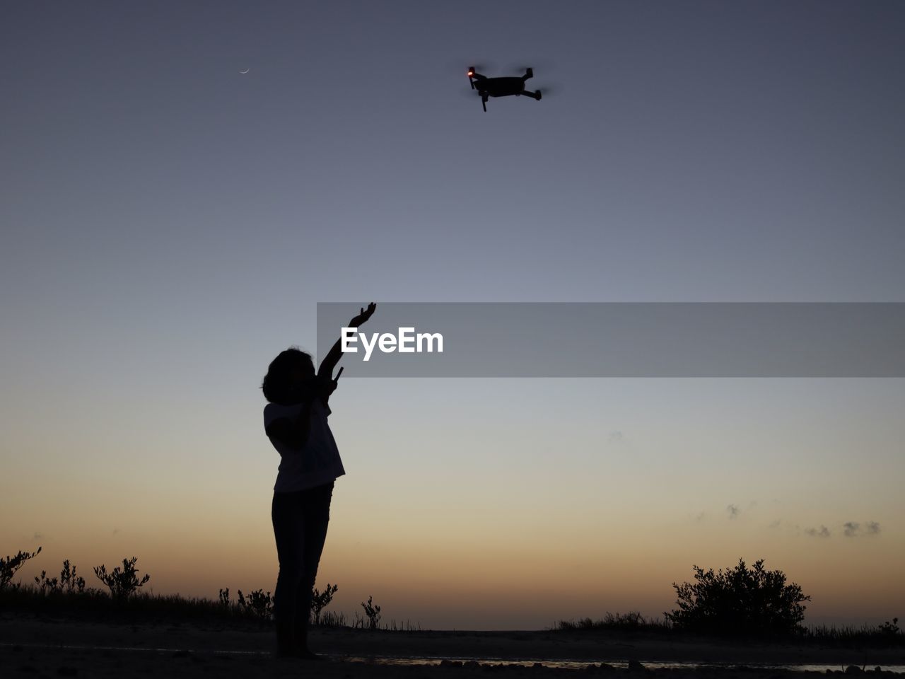 LOW ANGLE VIEW OF SILHOUETTE MAN FLYING AGAINST SKY