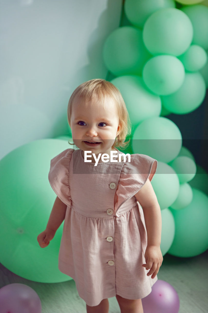 Cute baby girl with balloons