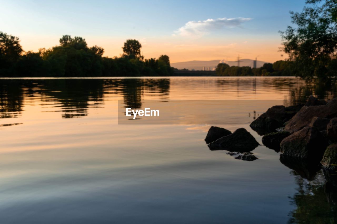 Scenic view of lake against sky during sunset