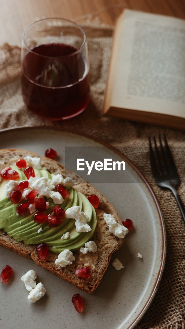 Avocado toast with pomegranate and goat cheese toppings