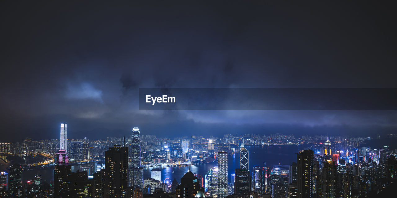 high angle view of illuminated buildings against sky at night