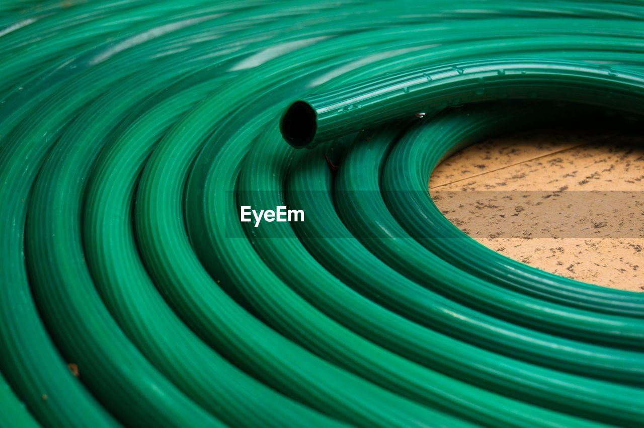 Close-up of green pipe on floor