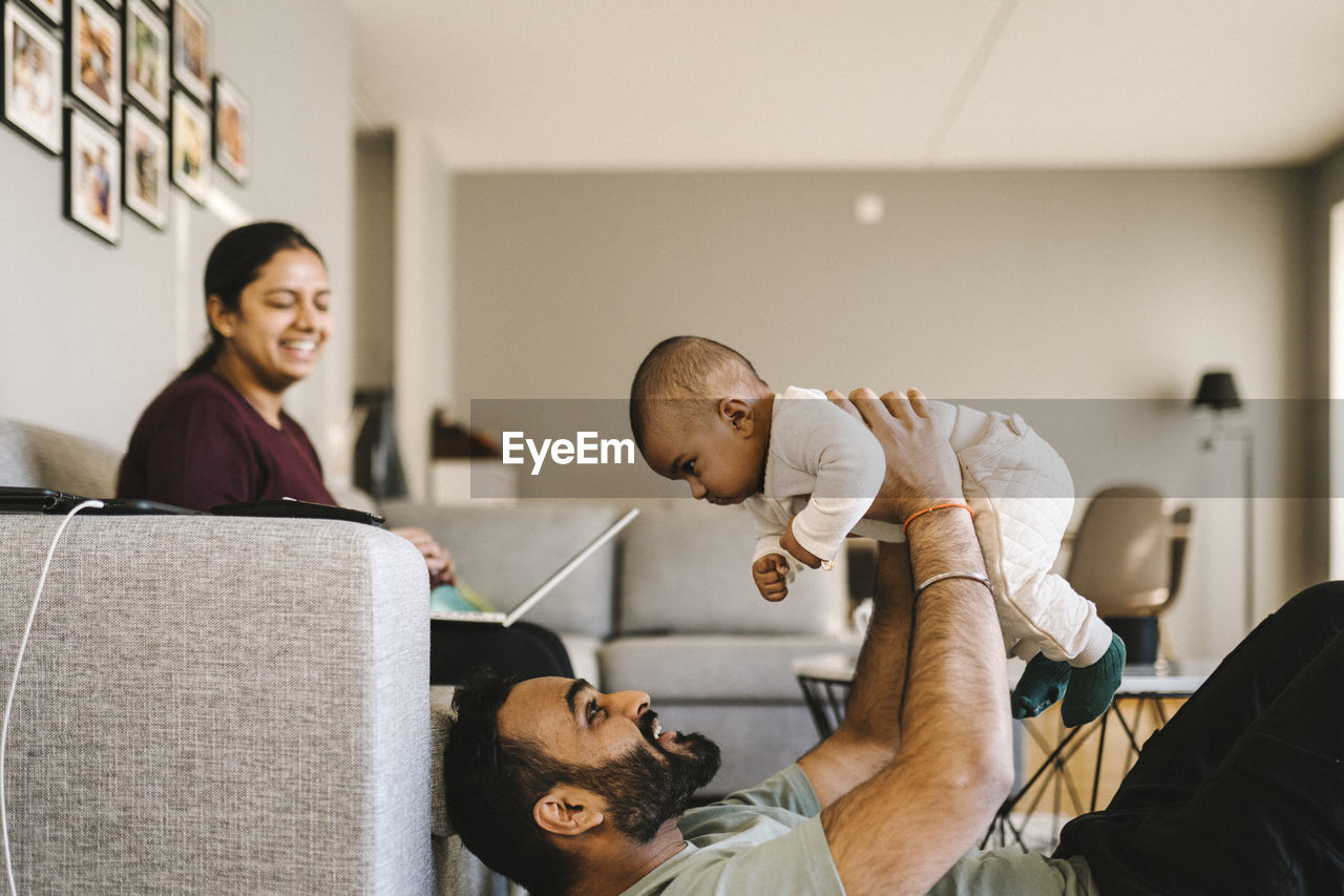 Father and mother with baby in living room