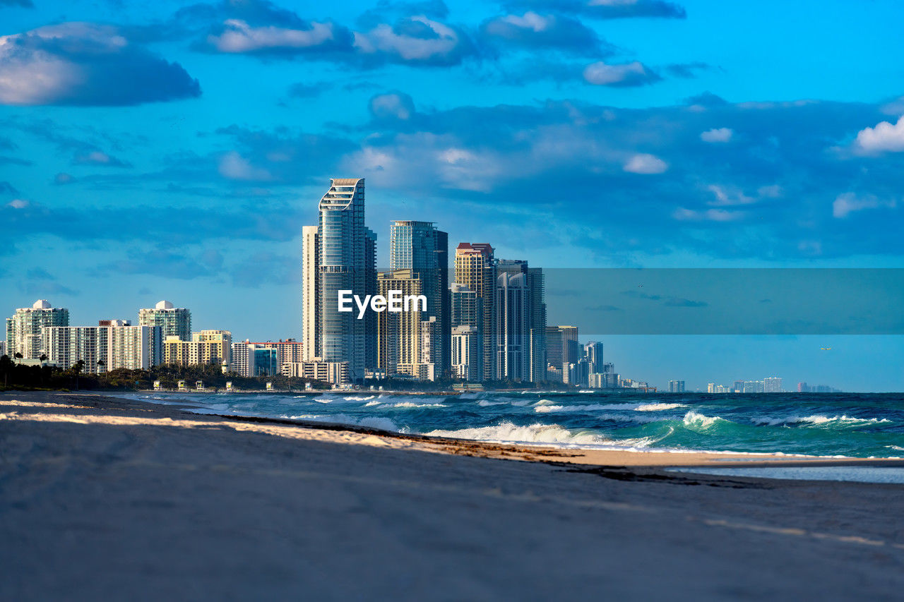 Skyline of buildings at sunny isles beach viewed from surfside beach in miami, united states