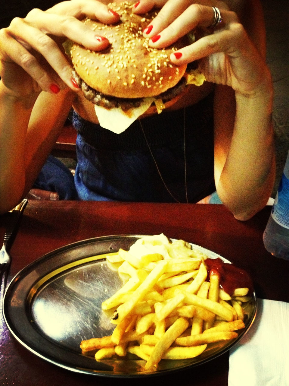 Woman having burger and french fries