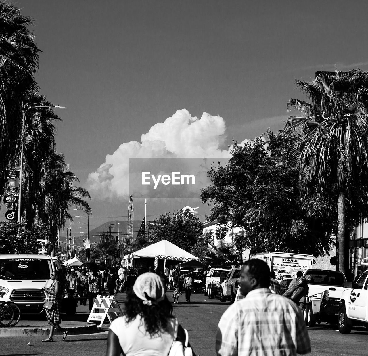 People walking on street against sky