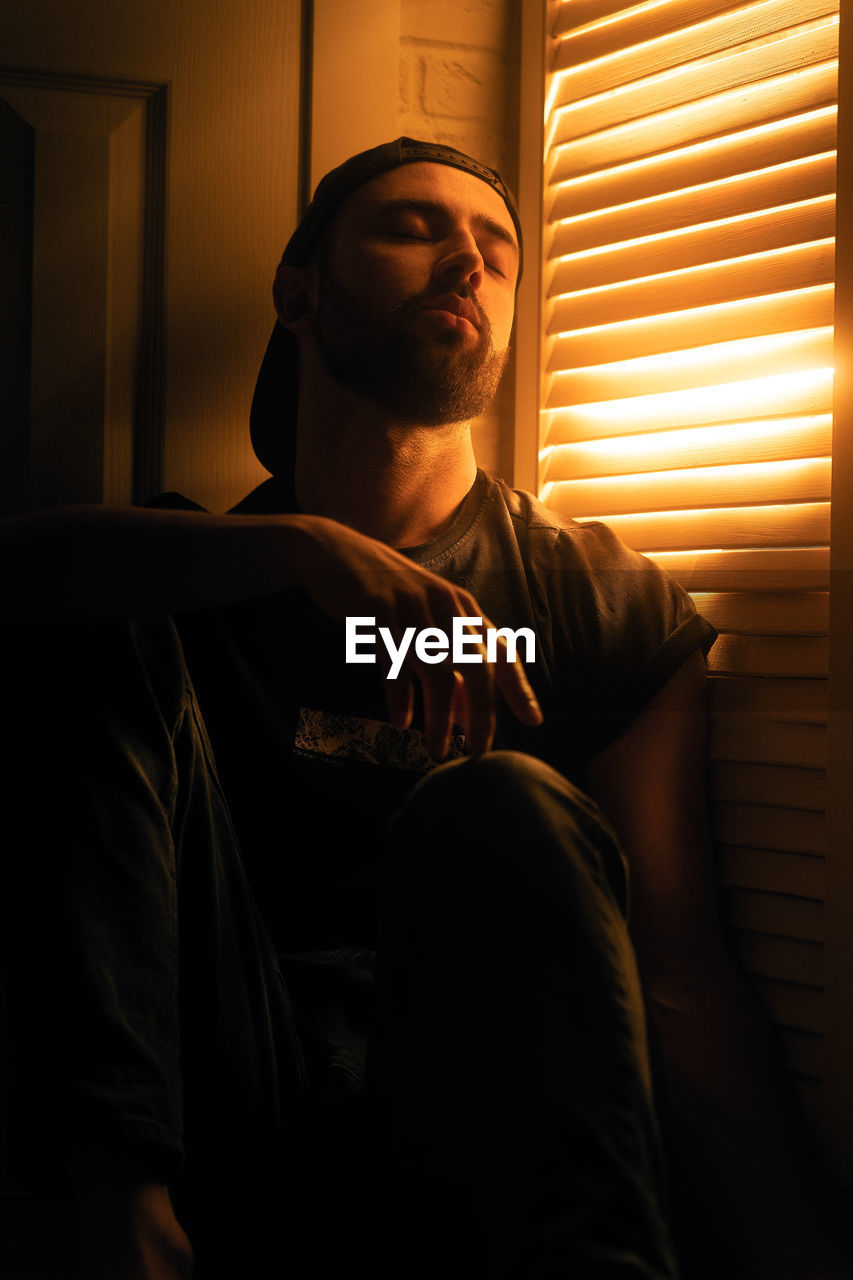 Portrait of man looking through window