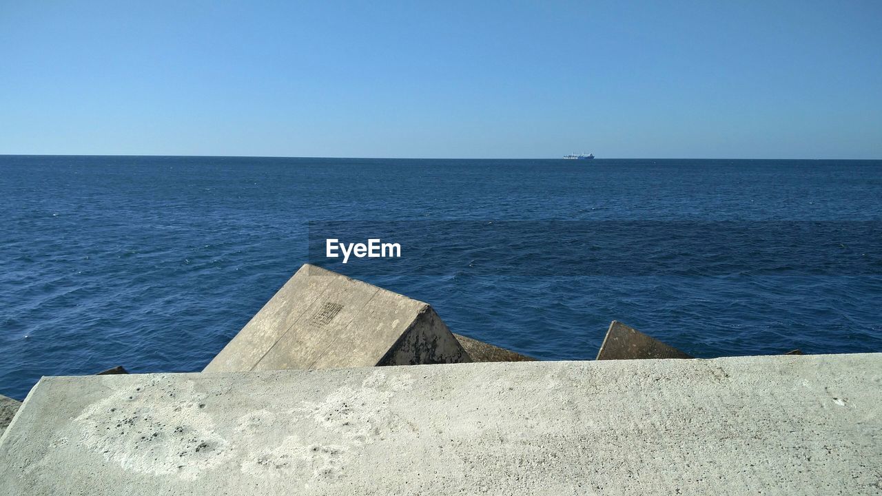 Scenic view of sea against clear blue sky