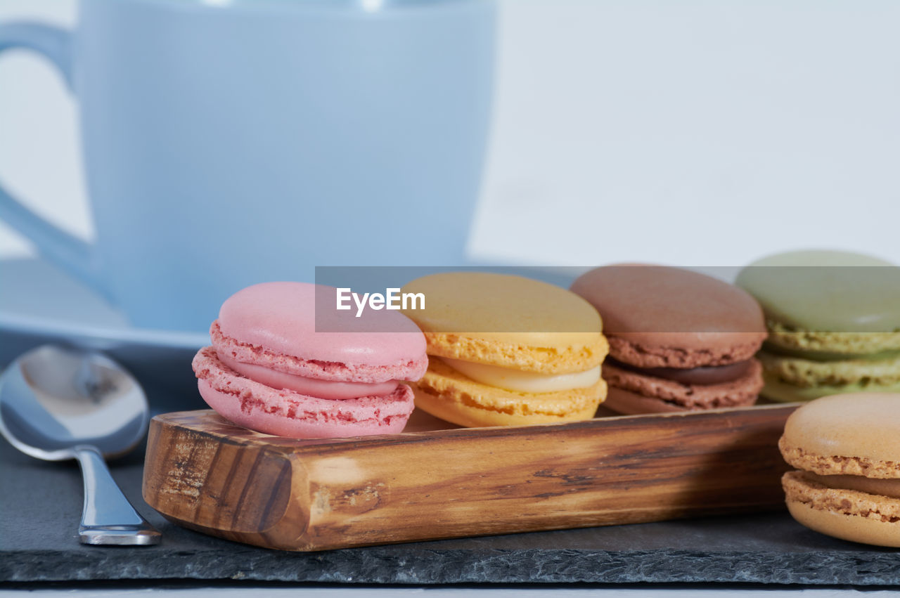 CLOSE-UP OF MACAROONS ON WOODEN TABLE