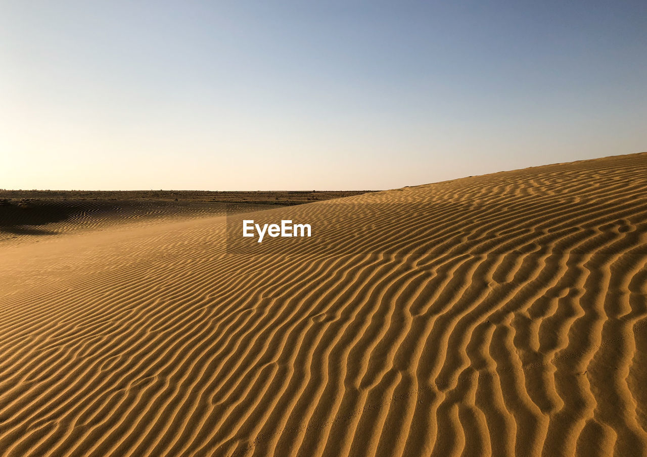 Scenic view of desert against clear sky