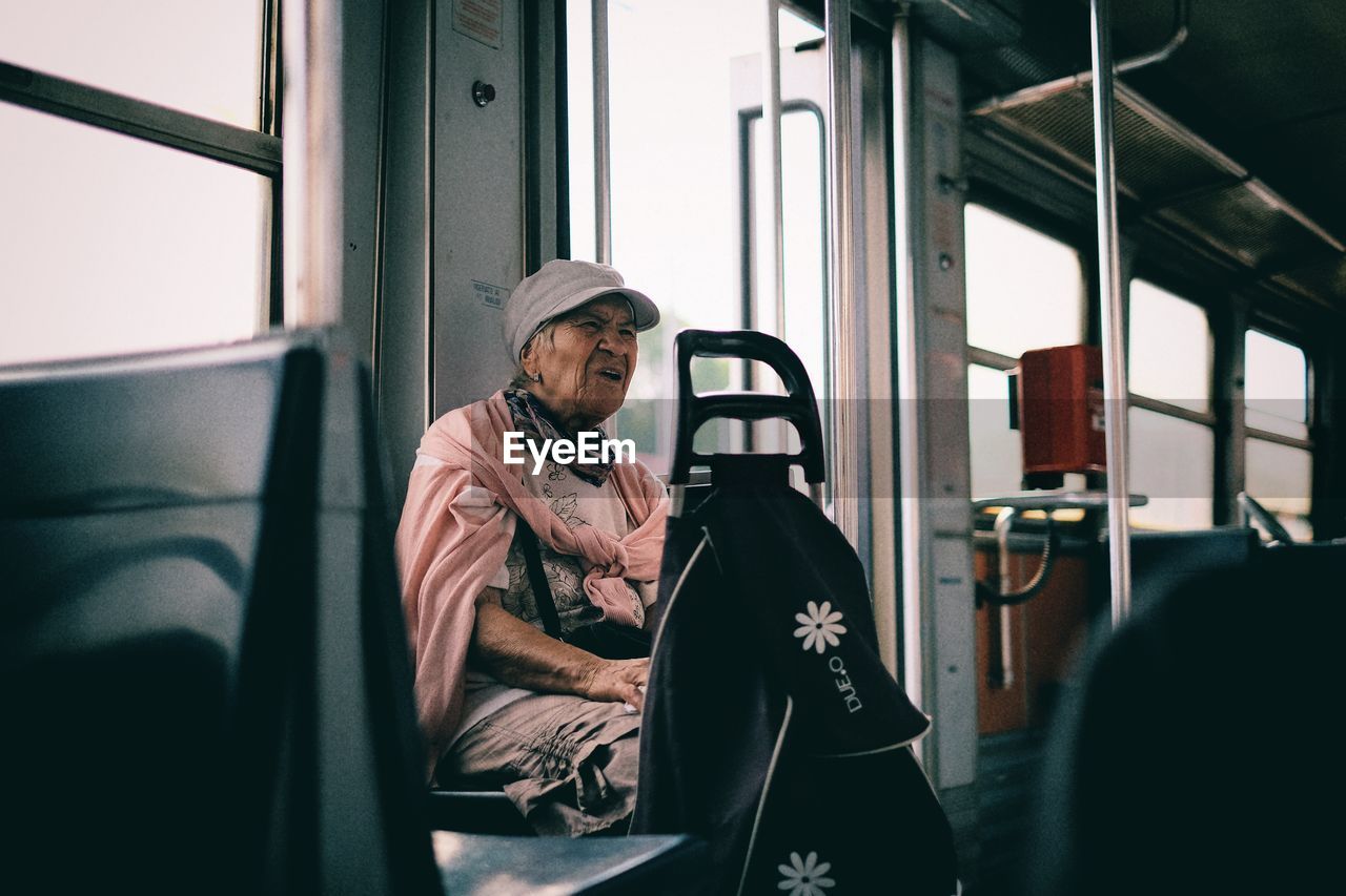 WOMAN LOOKING THROUGH WINDOW