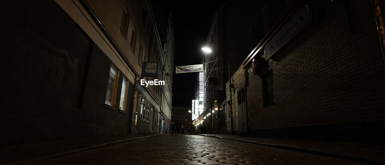 EMPTY ALLEY AMIDST BUILDINGS IN CITY